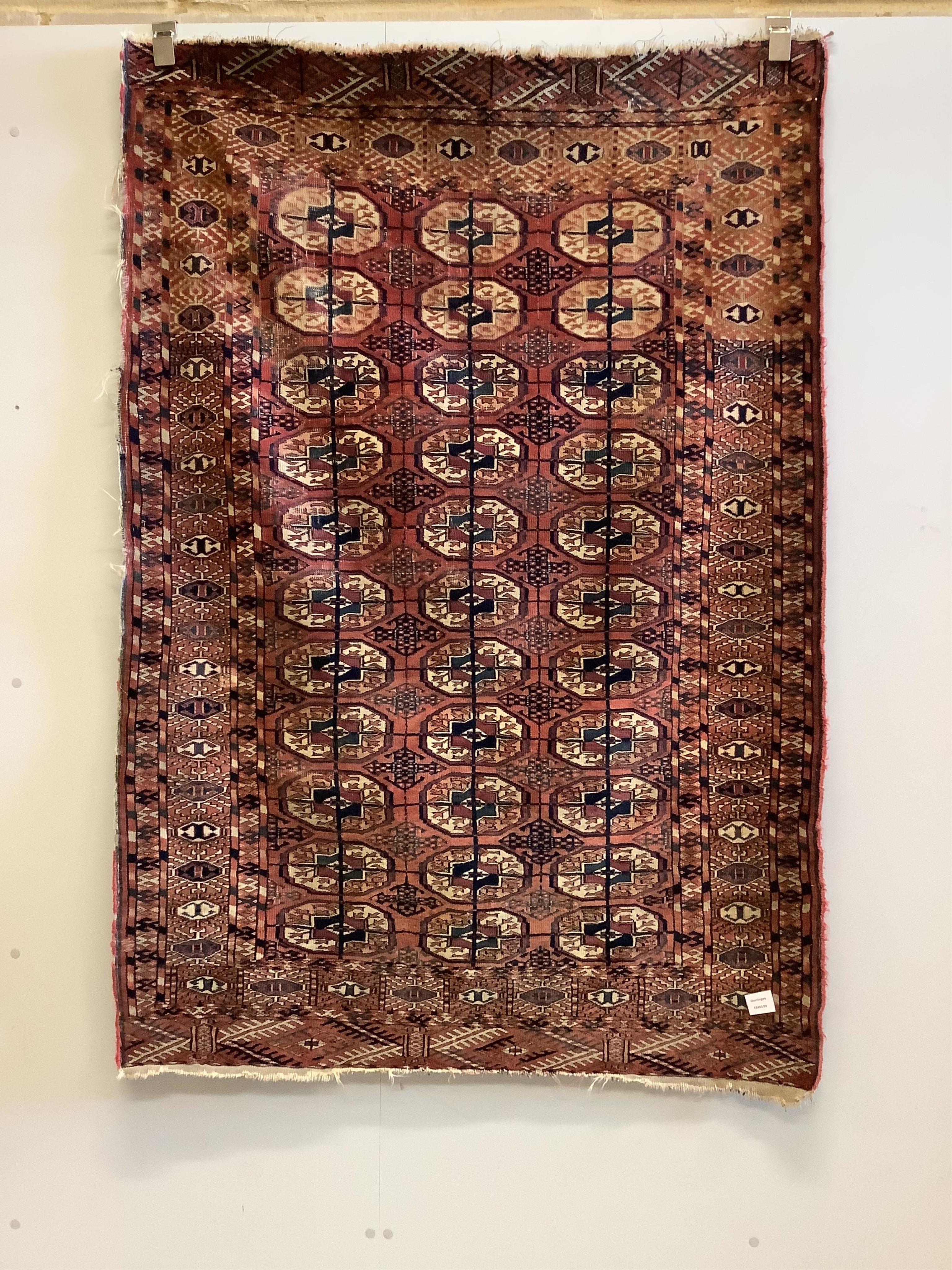 A Tekke Turkoman red ground rug, woven with rows of boteh, 160 x 108cm. Condition - poor to fair